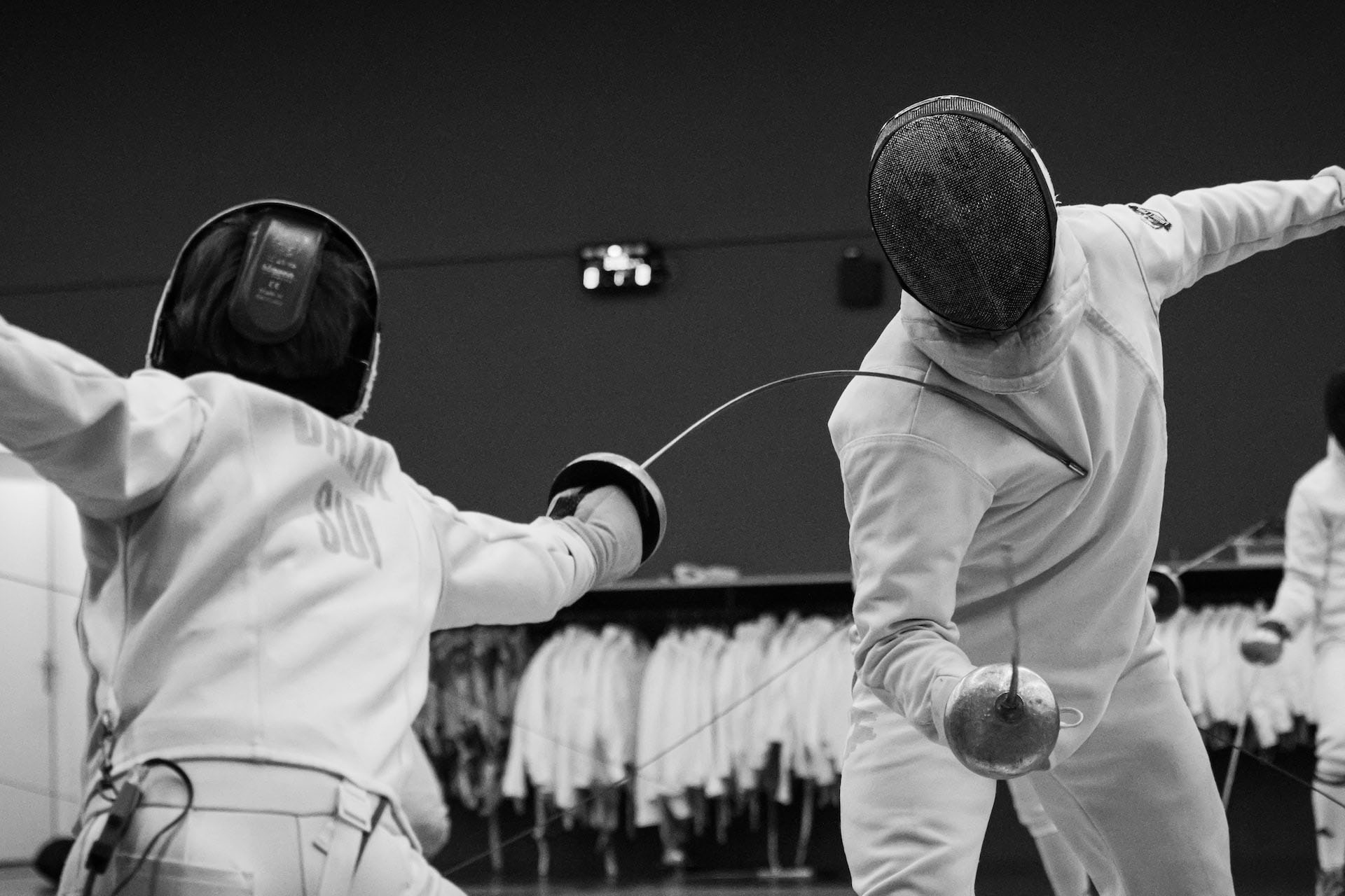 Two people fencing